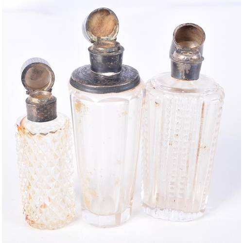 832 - THREE SILVER TOPPED SCENT BOTTLES.  Largest 9.4cm high (3)