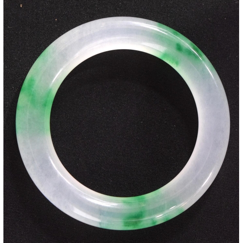 833 - A TWO TONE JADE BANGLE.  Internal 5.5cm diameter, weight 66g