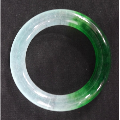 834 - A TWO TONE JADE BANGLE.  Internal 5.9cm diameter, weight 88g