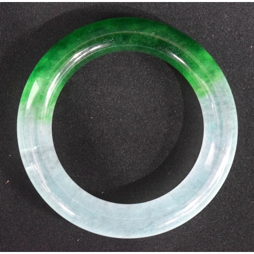 834 - A TWO TONE JADE BANGLE.  Internal 5.9cm diameter, weight 88g