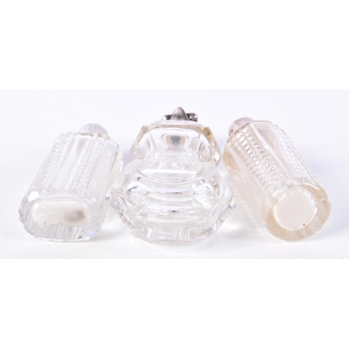 869 - THREE SILVER TOPPED SCENT BOTTLES.  Largest 11.4cm high (3)