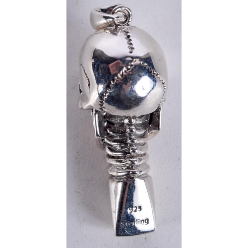 909 - A SILVER SKULL WHISTLE WITH  GEM SET EYES.  Stamped 925, 5cm x 1.6cm, weight 17.6g