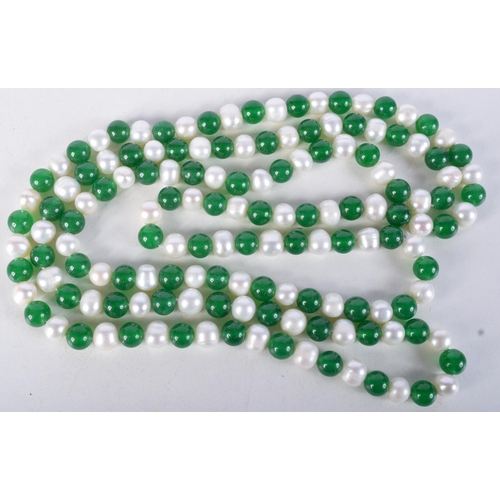 923 - A STRING OF JADE AND PEARL TYPE BEADS.  Length 120cm, Bead size 7cm, weight 112g