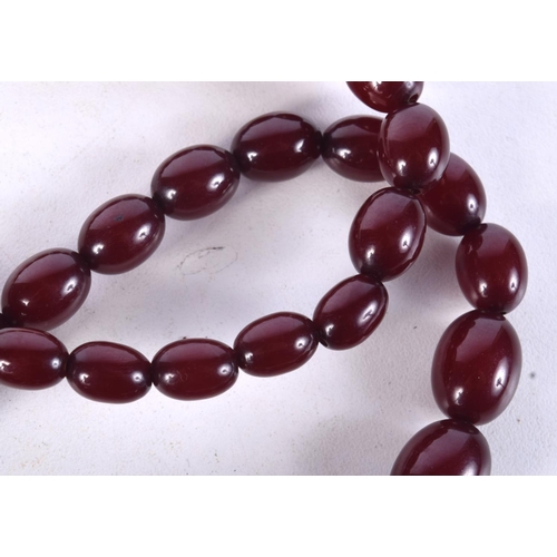 957 - CHERRY AMBER TYPE NECKLACE.  Largest bead 20.9mm, weight 65g