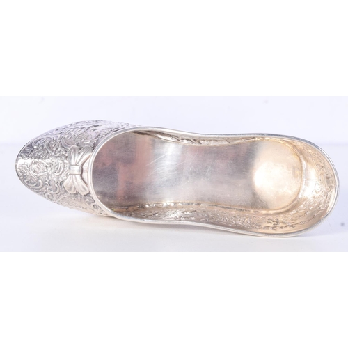 979 - A CHASED SILVER SHOE.  Hallmarked London 1901, 7.2cm x 13.8cm x 4.3cm, weight 113.3g