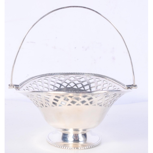 981 - AN EARLY 20TH CENTURY SWING HANDLED BASKET.  Hallmarked Birmingham 1916, 5.5cm x 14.2cm x 9.8cm, wei... 