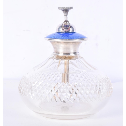 982 - A CUT GLASS ATOMISER WITH A BLUE GUILLOCHE ENAMEL DECORATION.  11.4cm x 10cm