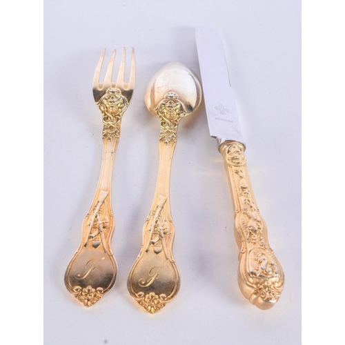 992 - A GILT KNIFE, FORK AND SPOON CHRISTENING SET.  21cm long, weight 186g (3)