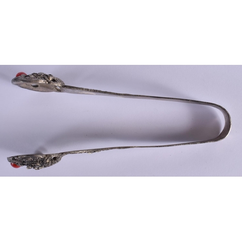 1512 - A PAIR OF EARLY 20TH CENTURY TIBETAN WHITE METAL TONGS inset with coral type stones. 15 cm long.