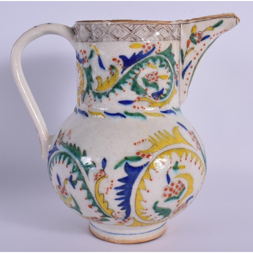 1516 - AN OTTOMAN TURKISH KUTAHYA HOLY WATER JUG painted with motifs. 16.5 cm high.