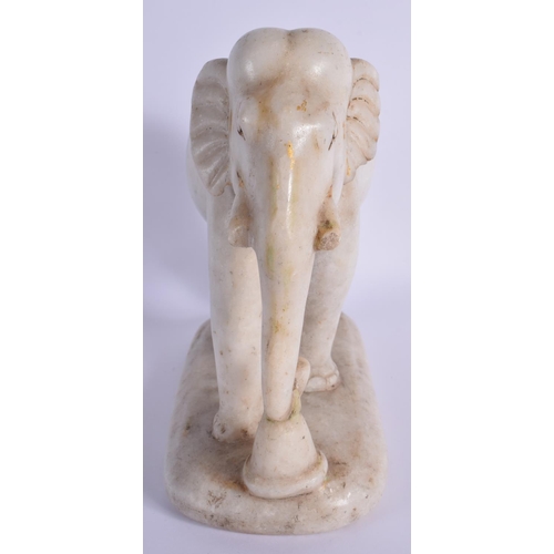 1519 - A 19TH CENTURY INDIAN RAJASTHAN CARVED MARBLE FIGURE OF AN ELEPHANT modelled roaming. 21 cm x 21 cm.