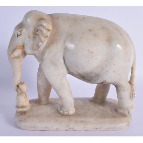 1519 - A 19TH CENTURY INDIAN RAJASTHAN CARVED MARBLE FIGURE OF AN ELEPHANT modelled roaming. 21 cm x 21 cm.