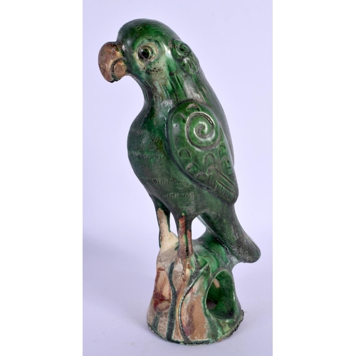 1541 - A CHINESE QING DYNASTY GREEN GLAZE FIGURE OF A PARROT modelled upon a naturalistic base. 21 cm high.