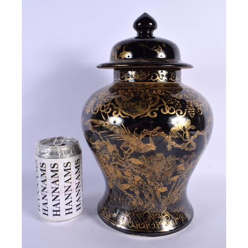 1584 - A RARE 19TH CENTURY CHINESE BLACK GLAZED VASE AND COVER Qing, gilded with foliage. 30 cm x 14 cm.