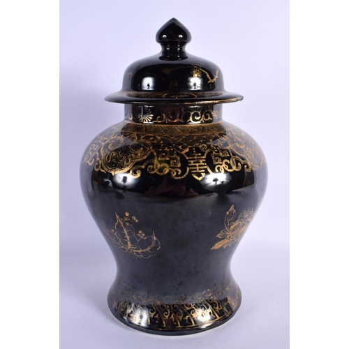 1584 - A RARE 19TH CENTURY CHINESE BLACK GLAZED VASE AND COVER Qing, gilded with foliage. 30 cm x 14 cm.