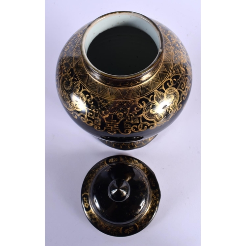 1584 - A RARE 19TH CENTURY CHINESE BLACK GLAZED VASE AND COVER Qing, gilded with foliage. 30 cm x 14 cm.