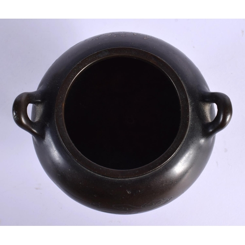 1588 - A 19TH CENTURY CHINESE TWIN HANDLED BRONZE CENSER with silver inlaid decoration. 11 cm x 9 cm.