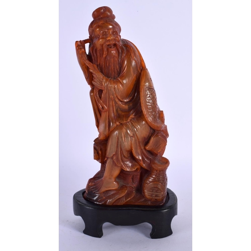 1634 - A 19TH CENTURY CHINESE CARVED BUFFALO HORN FIGURE OF A FISHERMAN Late Qing. 20 cm high overall.