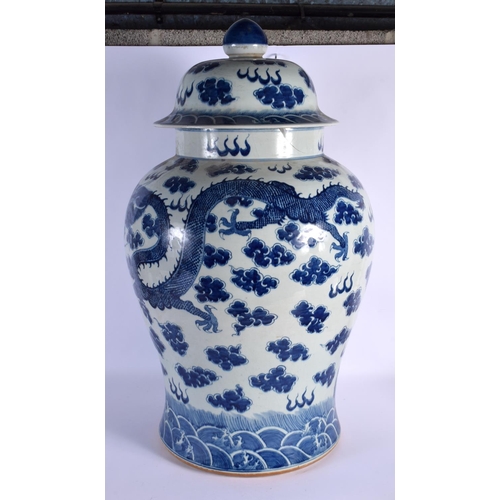 1639 - A LARGE CHINESE BLUE AND WHITE VASE AND COVER 20th Century, painted with dragons. 74 cm x 32 cm.