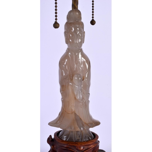 1658 - A 19TH CENTURY CHINESE CARVED AGATE FIGURAL LAMP upon a brass base. 60 cm high overall.