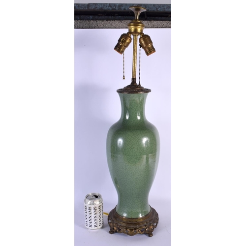 1659 - A LARGE 19TH CENTURY CHINESE CRACKLE GLAZED CELADON LAMP upon a brass base. 68 cm high overall.