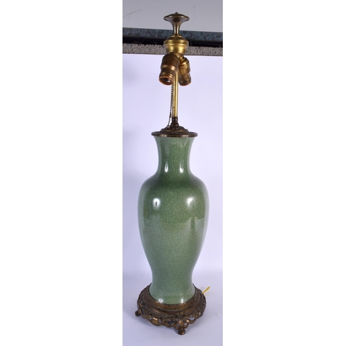 1659 - A LARGE 19TH CENTURY CHINESE CRACKLE GLAZED CELADON LAMP upon a brass base. 68 cm high overall.