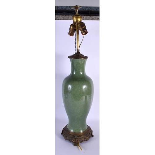 1659 - A LARGE 19TH CENTURY CHINESE CRACKLE GLAZED CELADON LAMP upon a brass base. 68 cm high overall.