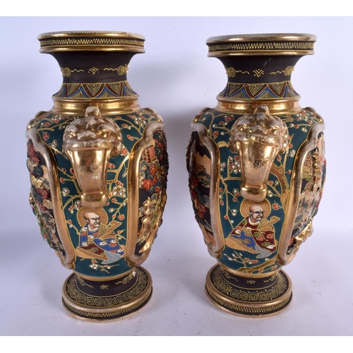 1719 - A PAIR OF JAPANESE TAISHO PERIOD SATSUMA TWIN HANDLED VASES decorated with figures. 32 cm x 18 cm.