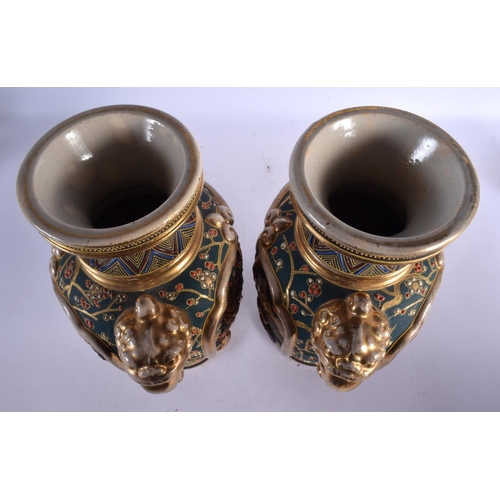 1719 - A PAIR OF JAPANESE TAISHO PERIOD SATSUMA TWIN HANDLED VASES decorated with figures. 32 cm x 18 cm.