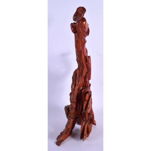 1738 - A 19TH CENTURY CHINESE CARVED WOOD FIGURAL GROUP modelled as a scholar beneath a female. 36 cm high.