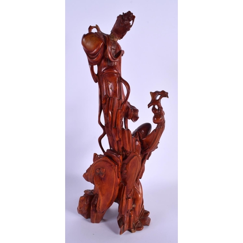 1738 - A 19TH CENTURY CHINESE CARVED WOOD FIGURAL GROUP modelled as a scholar beneath a female. 36 cm high.