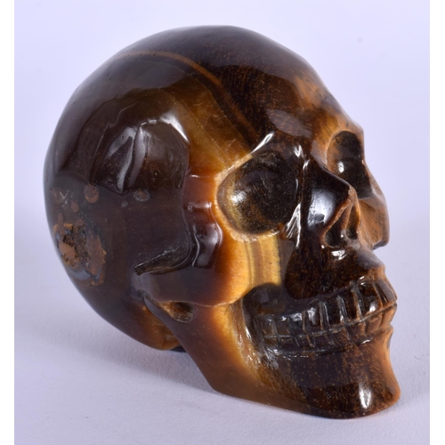 1742 - A CHINESE CARVED TIGERS EYE SKULL 20th Century. 7 cm x 5 cm.