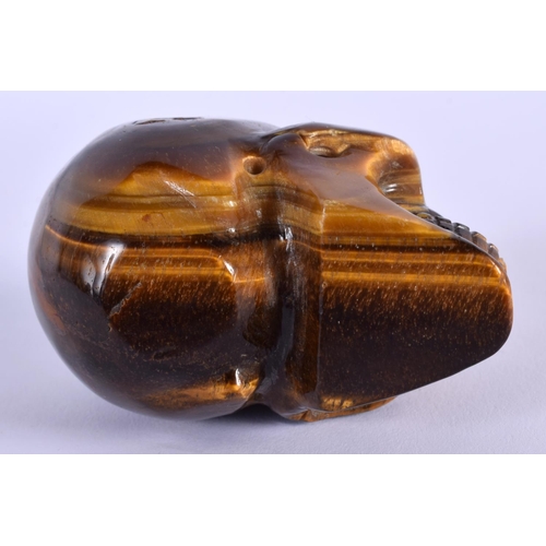 1742 - A CHINESE CARVED TIGERS EYE SKULL 20th Century. 7 cm x 5 cm.