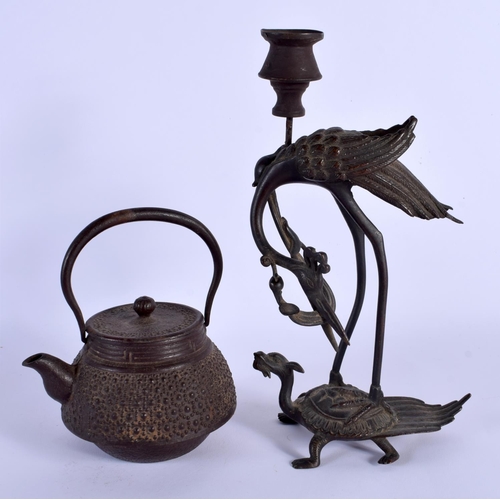 1756 - A 19TH CENTURY JAPANESE MEIJI PERIOD IRON TEAPOT AND COVER and a Japanese bronze candlestick. Larges... 