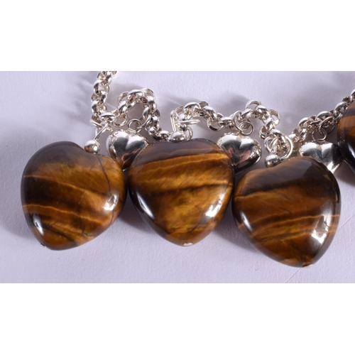 1901 - A CHINESE CARVED TIGERS EYE BRACELET 20th Century. 38 grams. 19.5 cm long.