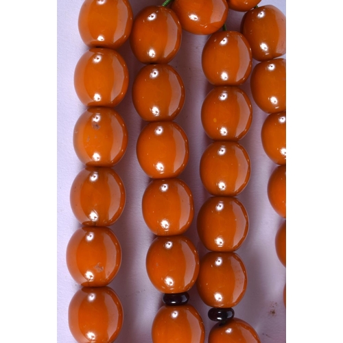 1908 - A MIDDLE EASTERN CARVED AMBER NECKLACE 20th Century. 70 cm long.