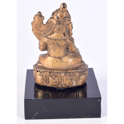 3019 - A small gilt bronze Buddha mounted on a plinth 6 cm.