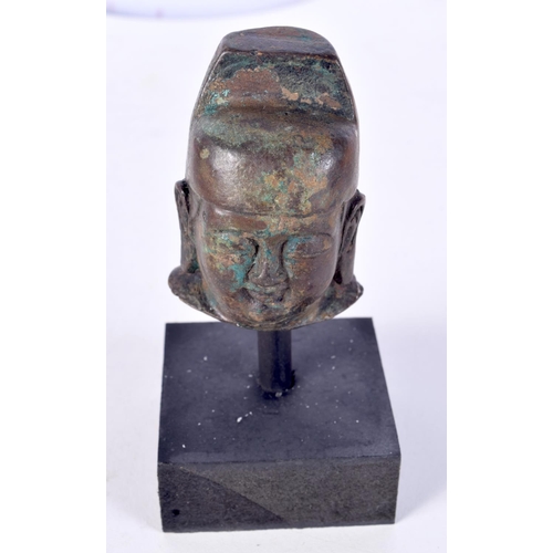 3021 - A small Chinese Tibetan bronze Buddha head on a stand 7cm.