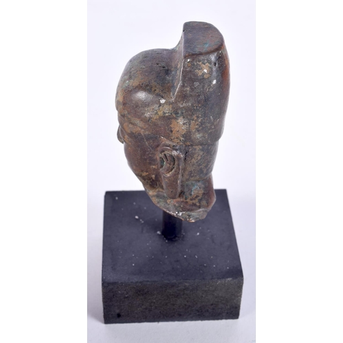 3021 - A small Chinese Tibetan bronze Buddha head on a stand 7cm.