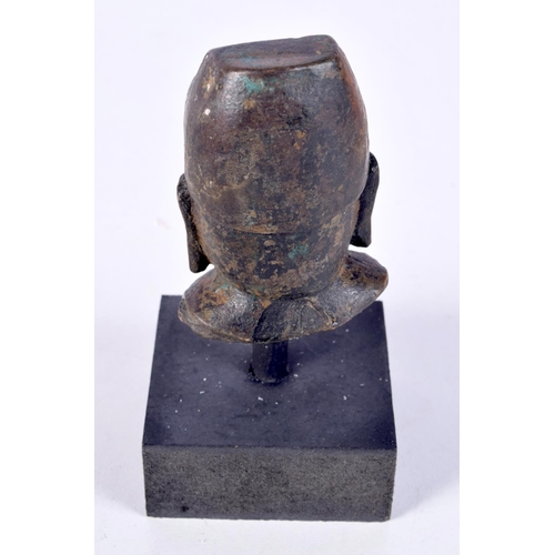 3021 - A small Chinese Tibetan bronze Buddha head on a stand 7cm.