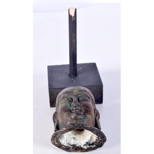 3021 - A small Chinese Tibetan bronze Buddha head on a stand 7cm.