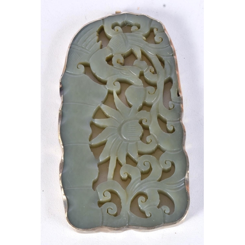 3025 - A carved Chinese  jade pendant with a white metal border 10.5 x 5.5 cm.