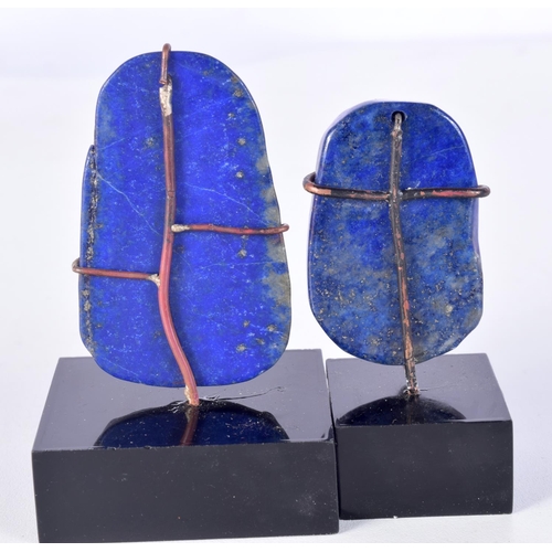 3030 - A pair of Lapis Lazuli carved pendants mounted on plinths 6 x 4 cm (2).