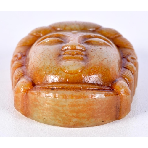 3034 - A Chinese carved jade Buddha head pendant with calligraphy on the rear of head 6.5 cm