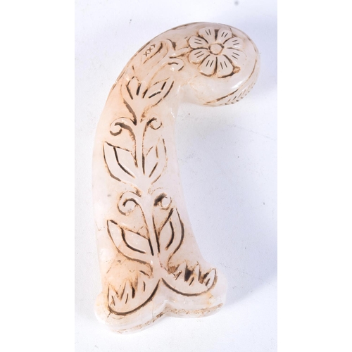 3045 - A carved hardstone dagger handle decorated in relief with a gilt floral pattern 13 cm.