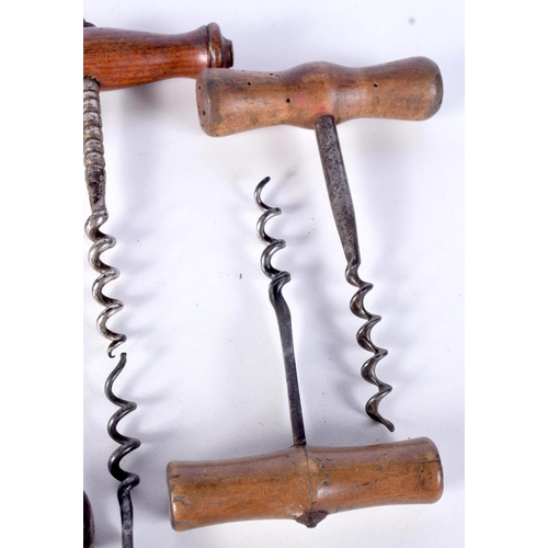 3060 - A collection of antique wooden handled corkscrews with facetted and flat shanks  (6).