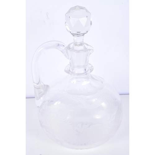 3093 - A Cut glass Claret jug engraved with a dragon 25 cm .