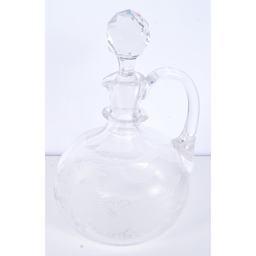 3093 - A Cut glass Claret jug engraved with a dragon 25 cm .