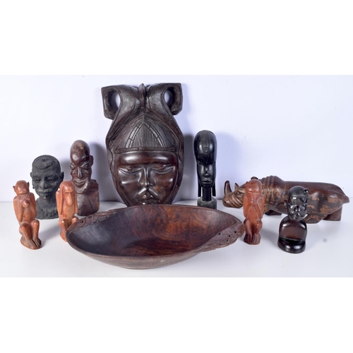 3094 - A collection of African tribal wooden carvings and a terracotta head . largest 40 cm.(10)