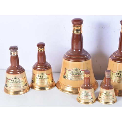 3098 - A collection of Wade Bells Scotch Whiskey bell decanters 25 cm (8).